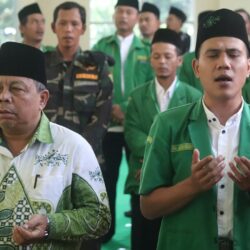man in green and white polo shirt