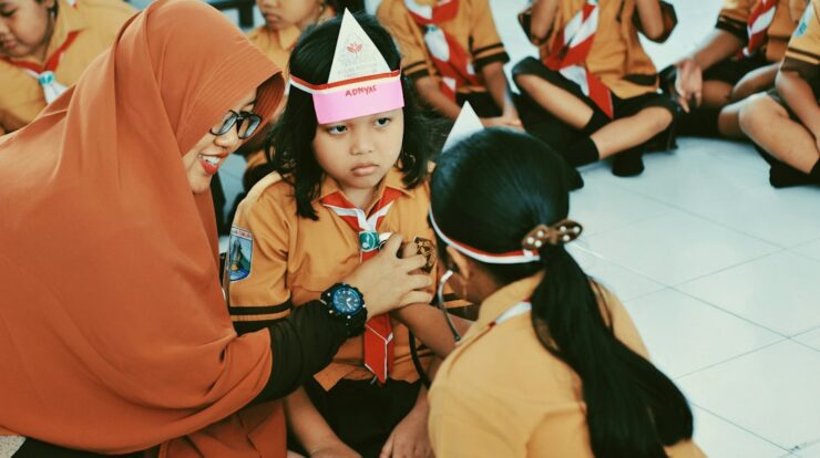 woman in orange long sleeve shirt wearing pink and white hat
