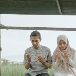 a man and a woman sitting on a bench