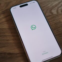 A white phone with a green message bubble on it