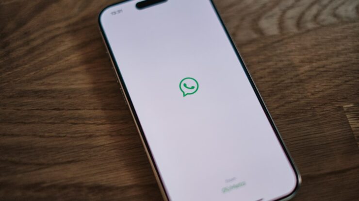 A white phone with a green message bubble on it