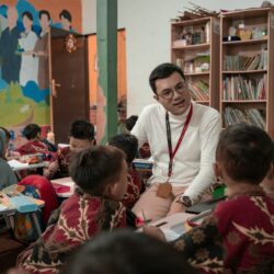 a man standing in front of a group of children