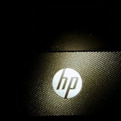 a close up of a hp logo on a laptop