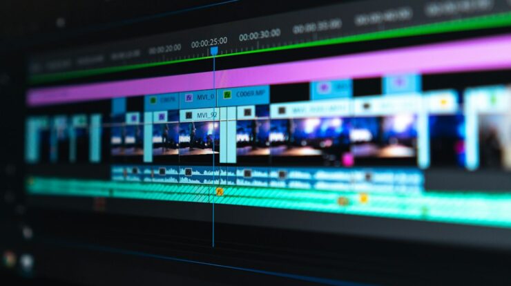 A video editing timeline with blue and purple clips on a dark screen