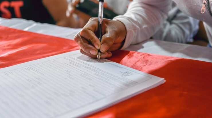 a person writing on a piece of paper