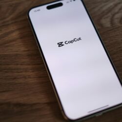 A close up of a cell phone on a wooden table