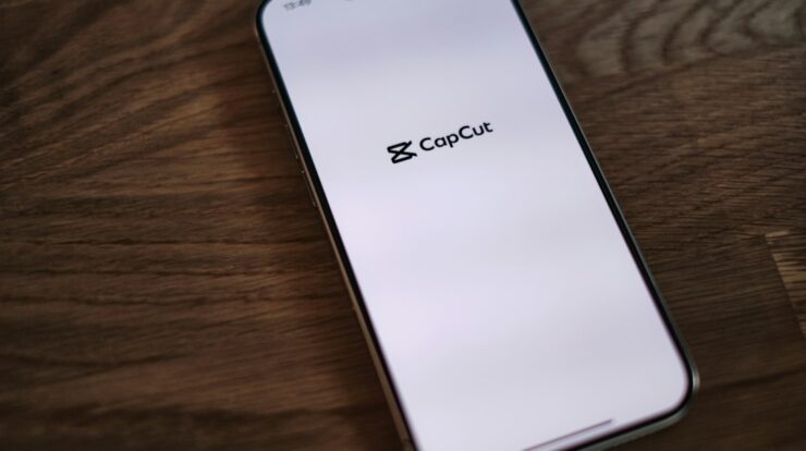 A close up of a cell phone on a wooden table