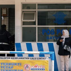People standing outside a police station building