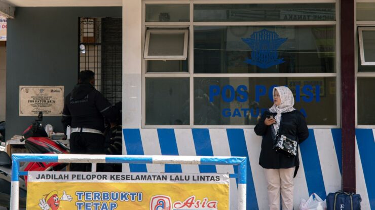 People standing outside a police station building