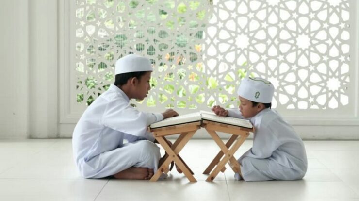 man in white thobe sitting on white floor tiles