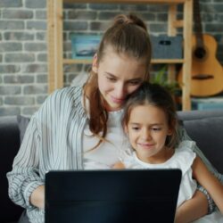 Mother and daughter looking at laptop together