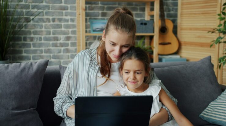 Mother and daughter looking at laptop together