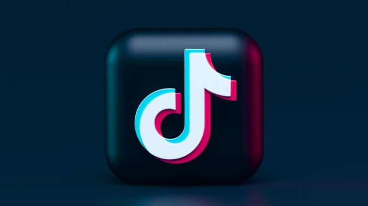 A three-dimensional TikTok logo with cyan and magenta chromatic aberration on a dark background