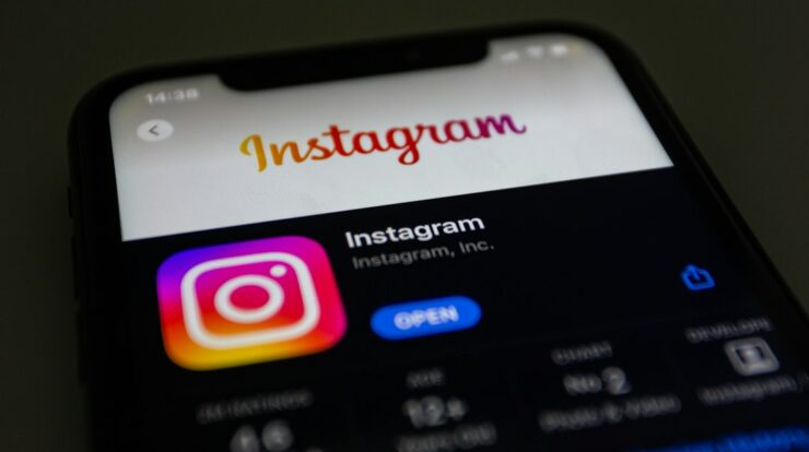 the instagram logo is displayed on an iphone