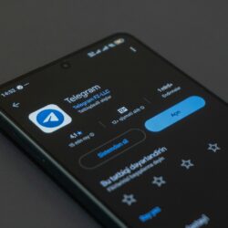 A phone screen displays the telegram app