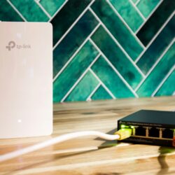 A wi-fi router and a network switch sit side-by-side