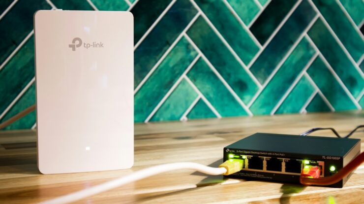 A wi-fi router and a network switch sit side-by-side
