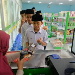 a woman is handing something to a boy in a store