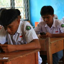 Students using smartphones in a classroom setting