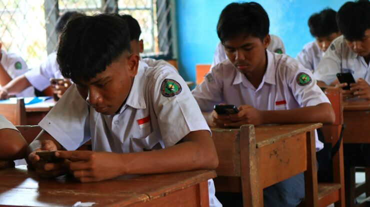 Students using smartphones in a classroom setting