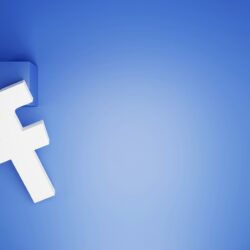 a white facebook logo on a blue background
