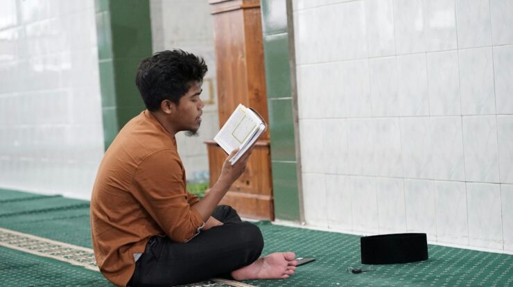a person sitting on the floor reading a book