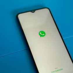 a white and black phone with a green whatsapp sticker on it