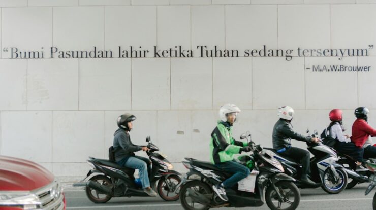 a group of people riding motorcycles down a street