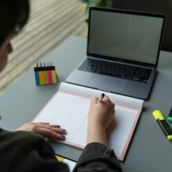 a man writing on a piece of paper