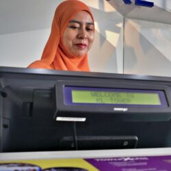 woman beside black monitor