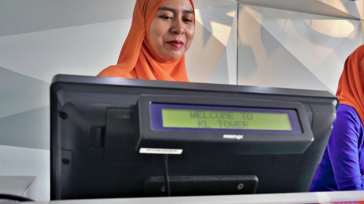 woman beside black monitor