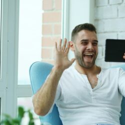 Man waving hello on a video call