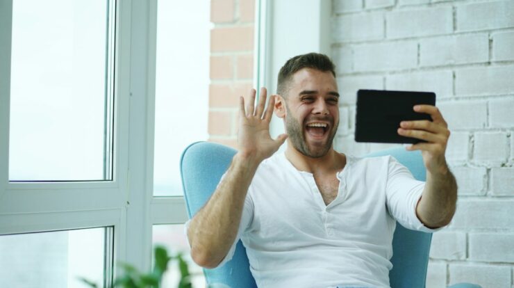 Man waving hello on a video call