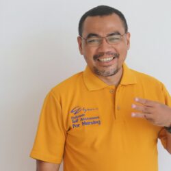 man in yellow polo shirt smiling