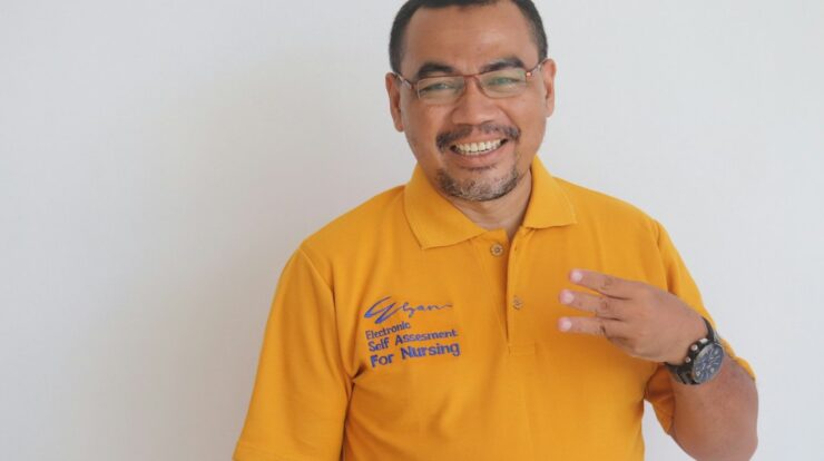 man in yellow polo shirt smiling