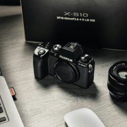 black nikon dslr camera beside white computer keyboard