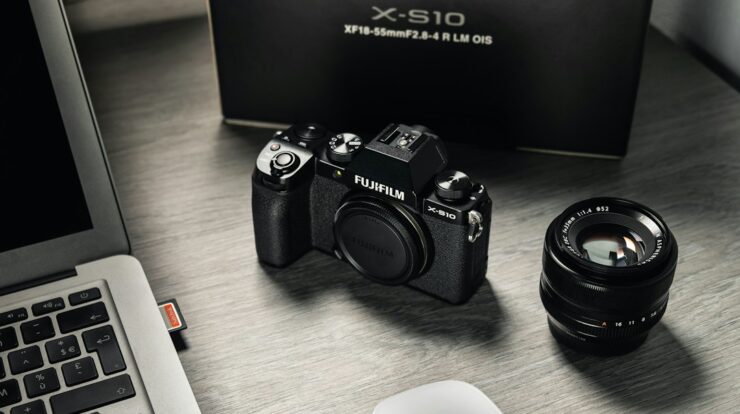 black nikon dslr camera beside white computer keyboard