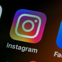 The Instagram app icon on a smartphone screen with other app icons