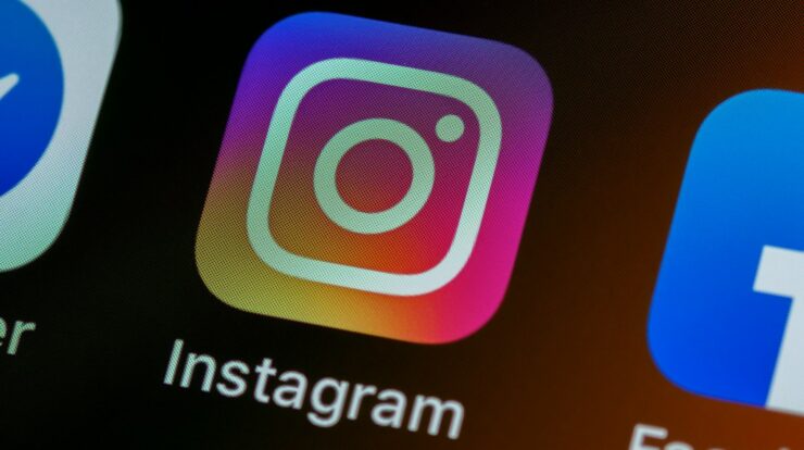 The Instagram app icon on a smartphone screen with other app icons