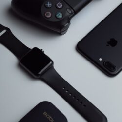 black iPhone 7 Plus and space gray Apple Watch with black sport band