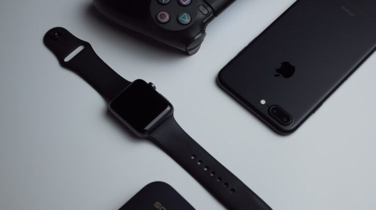 black iPhone 7 Plus and space gray Apple Watch with black sport band