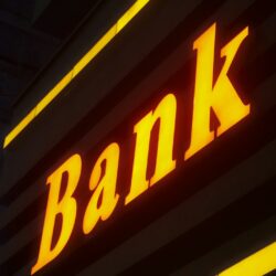 a bank sign lit up in the dark