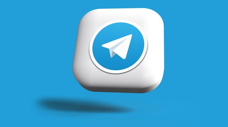 a blue and white square button with a paper airplane on it
