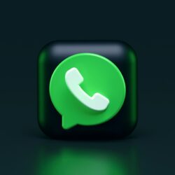 A green speech bubble icon with a white telephone handset on a dark background